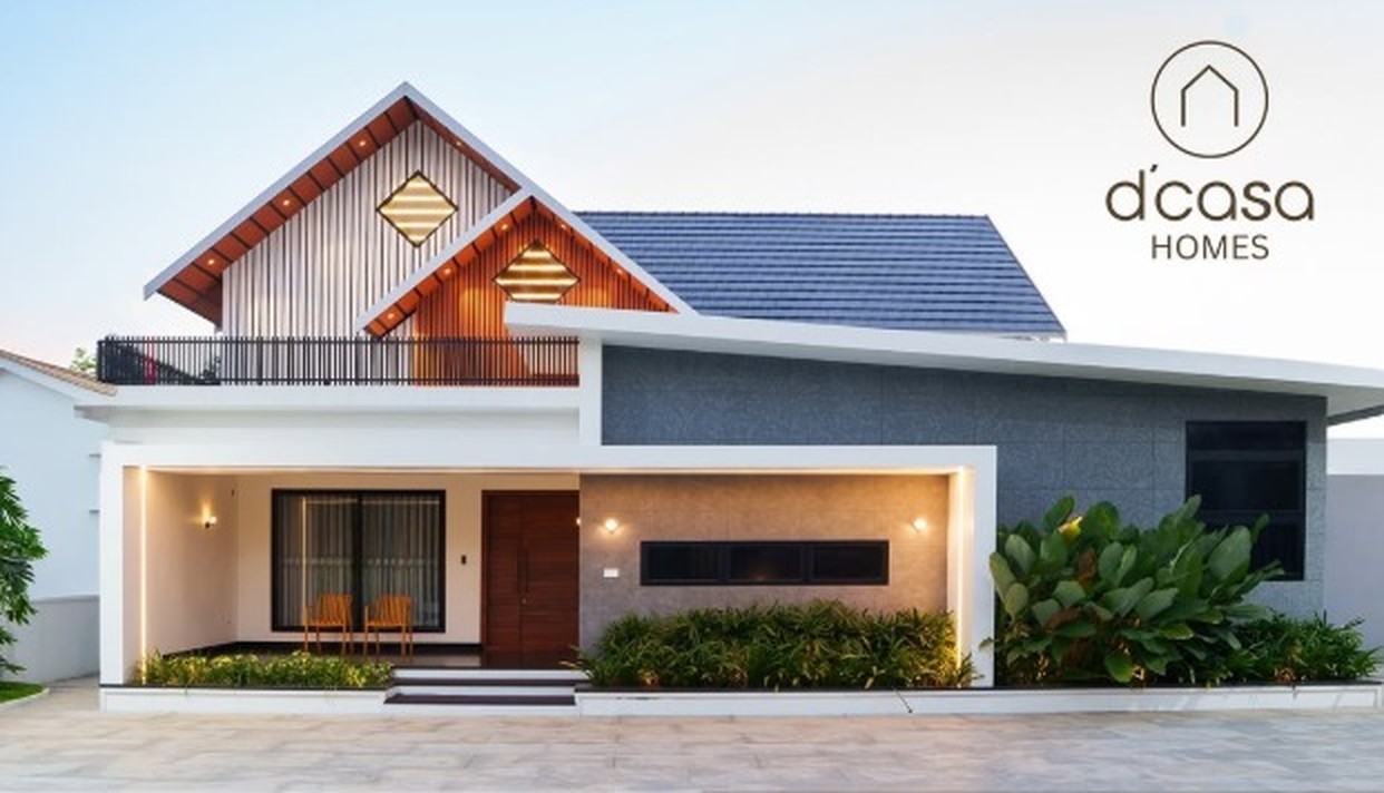 D'Casa Homes residence exterior at golden hour with tiled roofs and warm entrance lighting